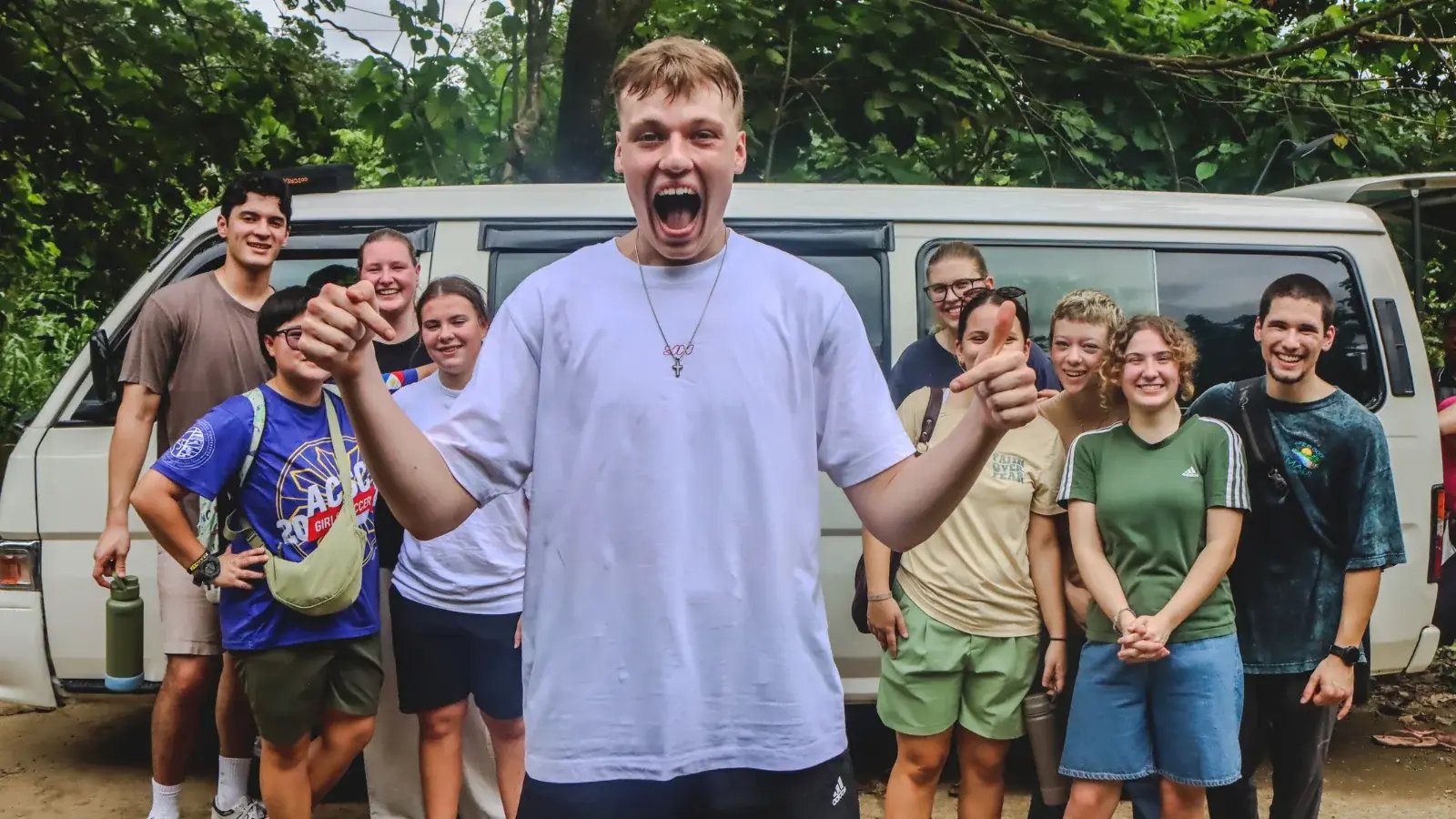 outreach team stands outside a van in the Philippines