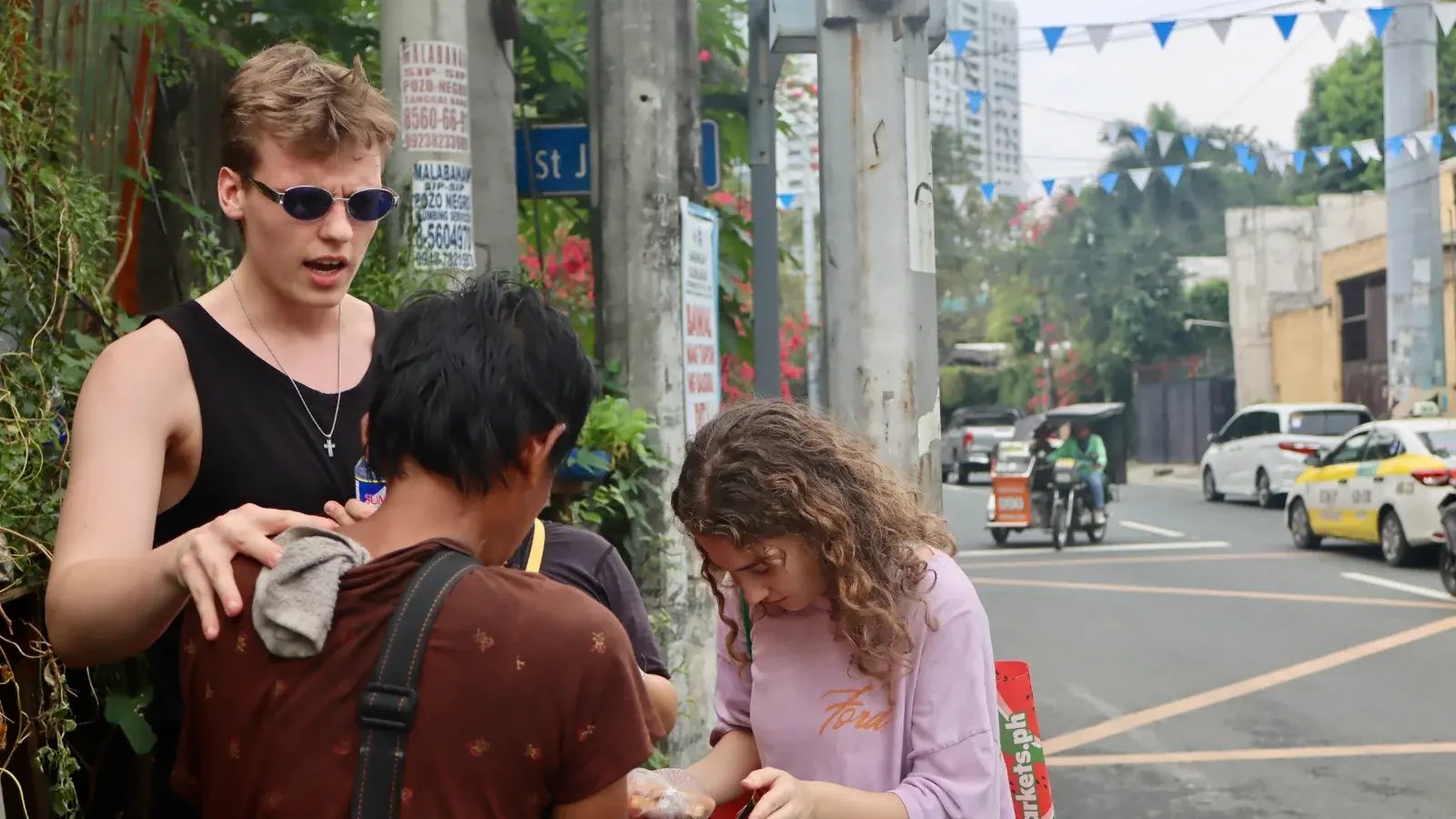 Missionaries praying for a man in the Philippines 