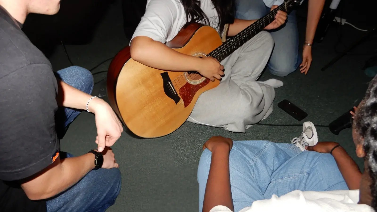 teens worshiping with a guitar