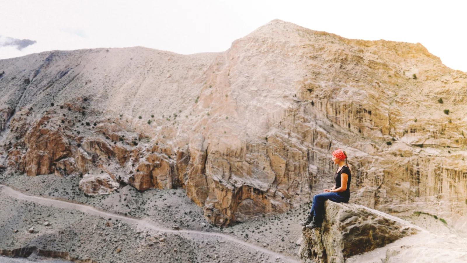 YWAM missionary sitting on a rocky cliff in Nepal